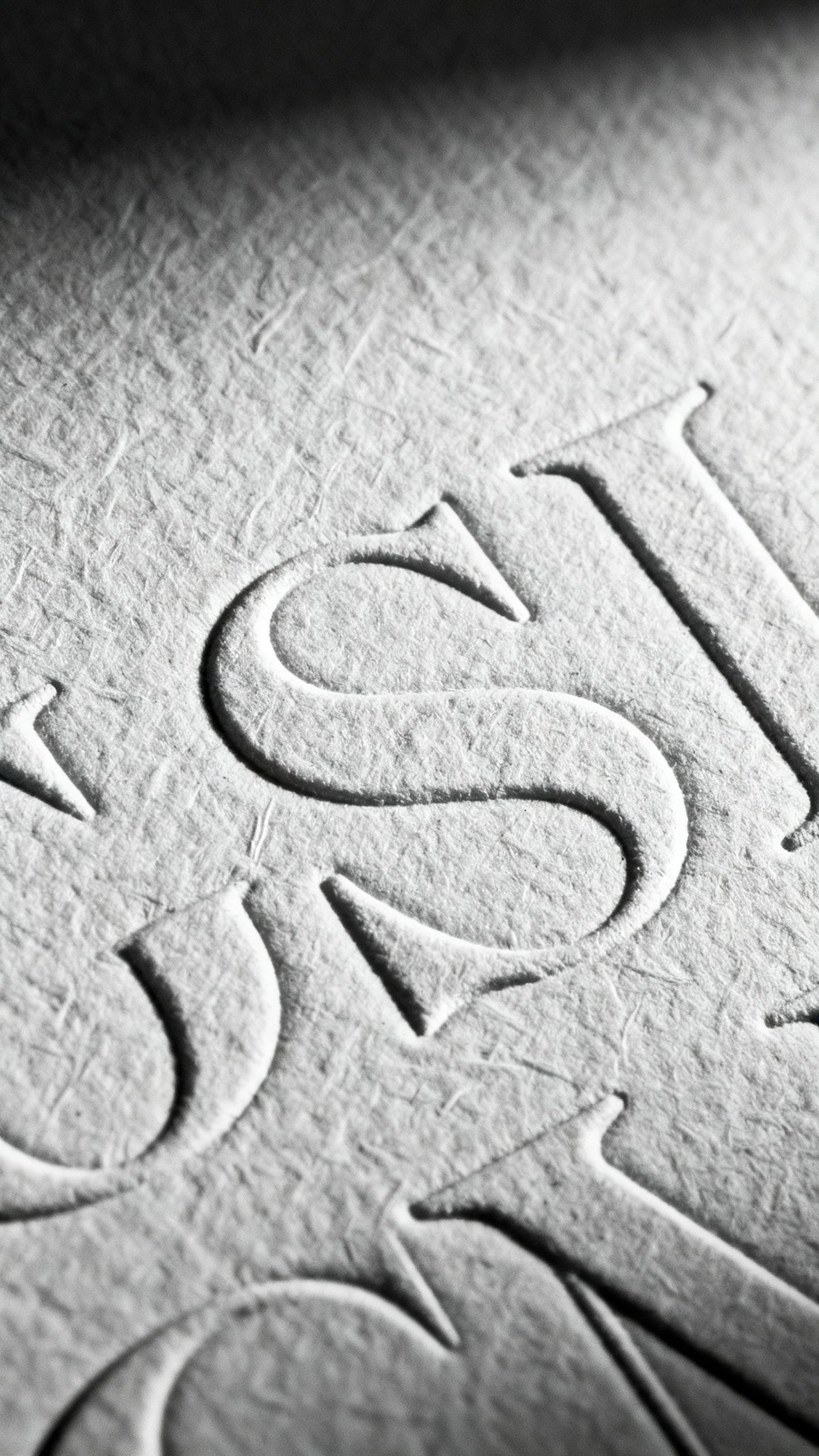 Closeup letterpress deboss on thick cotton rag paper