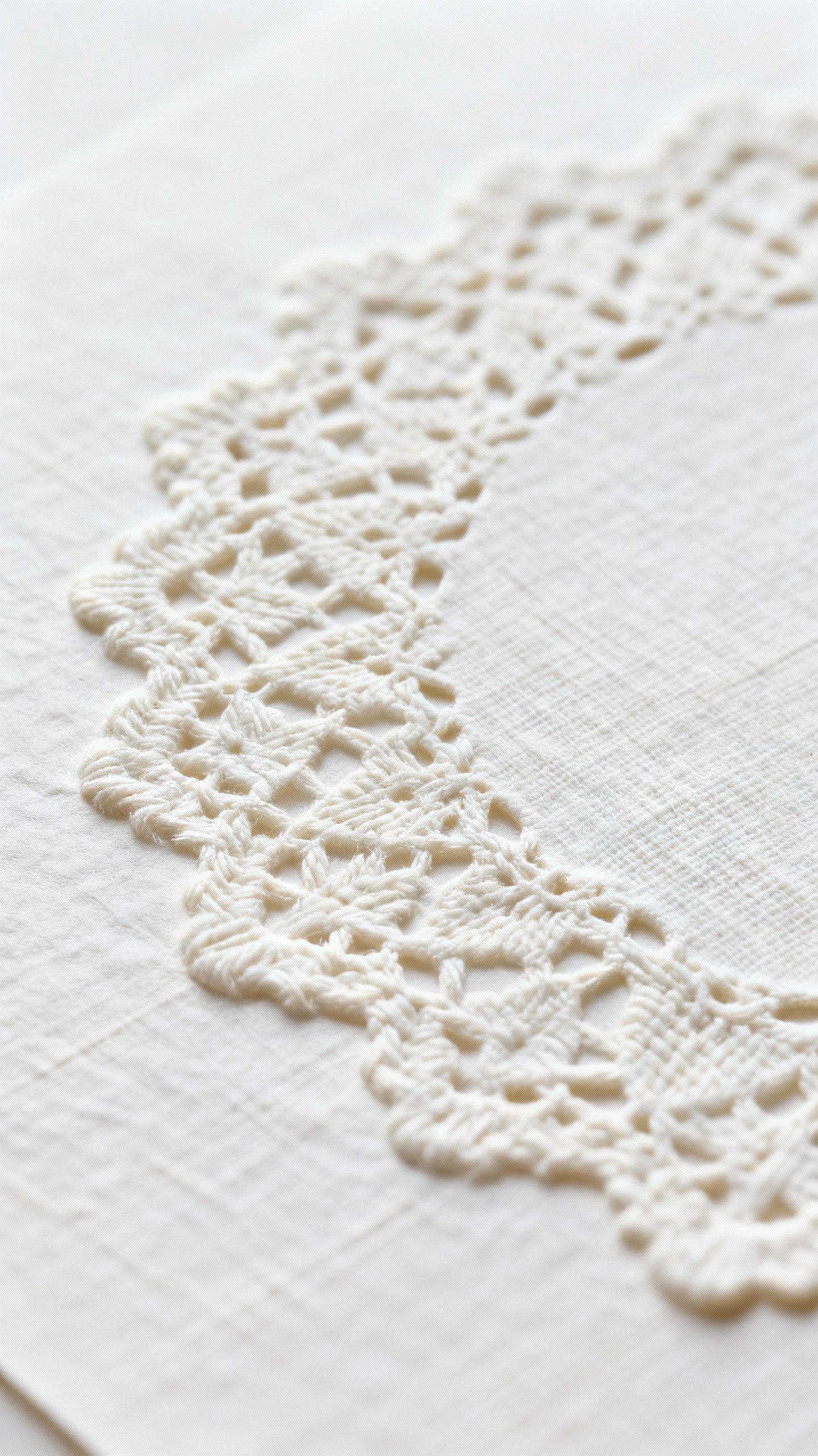 Macro shot embossed lace texture on white linen paper, tactile depth