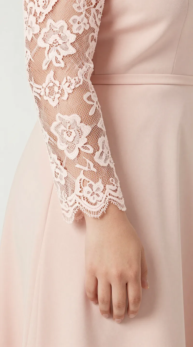 **Detail shot of lace sleeves on a plus-size blush pink dress**