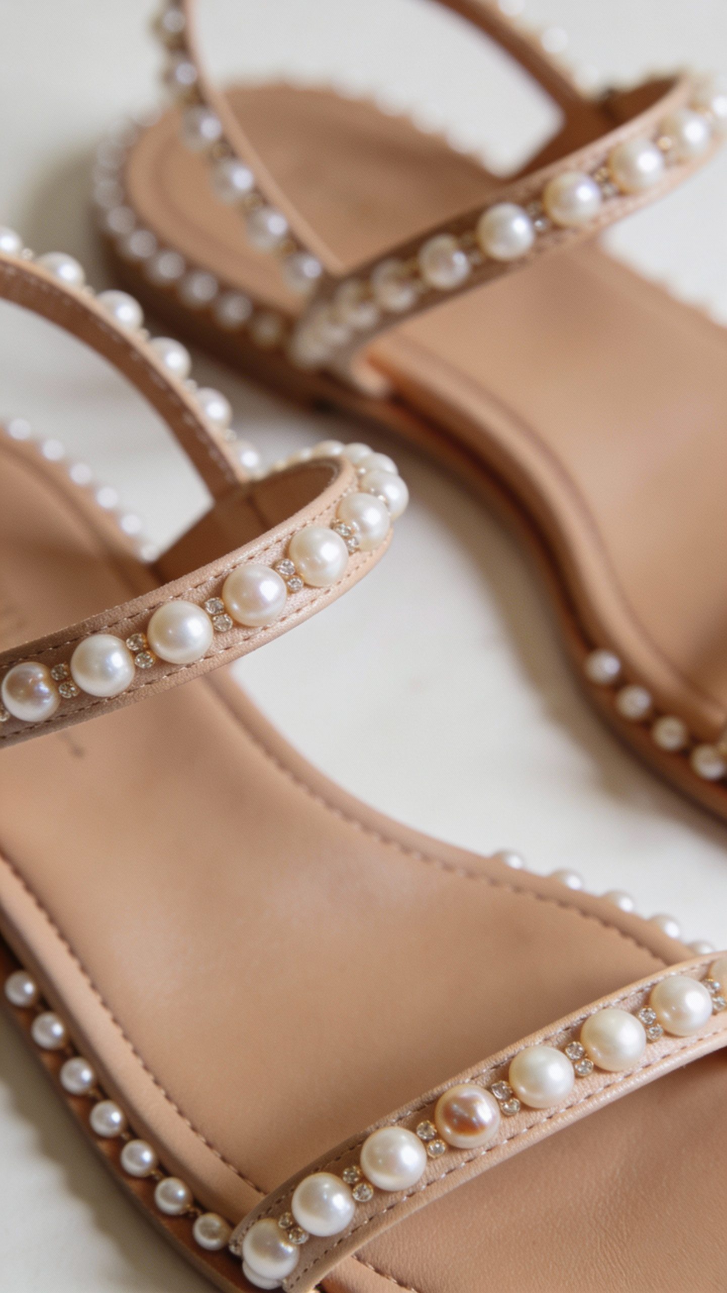 **Closeup of elegant flat sandals with pearl embellishments**
