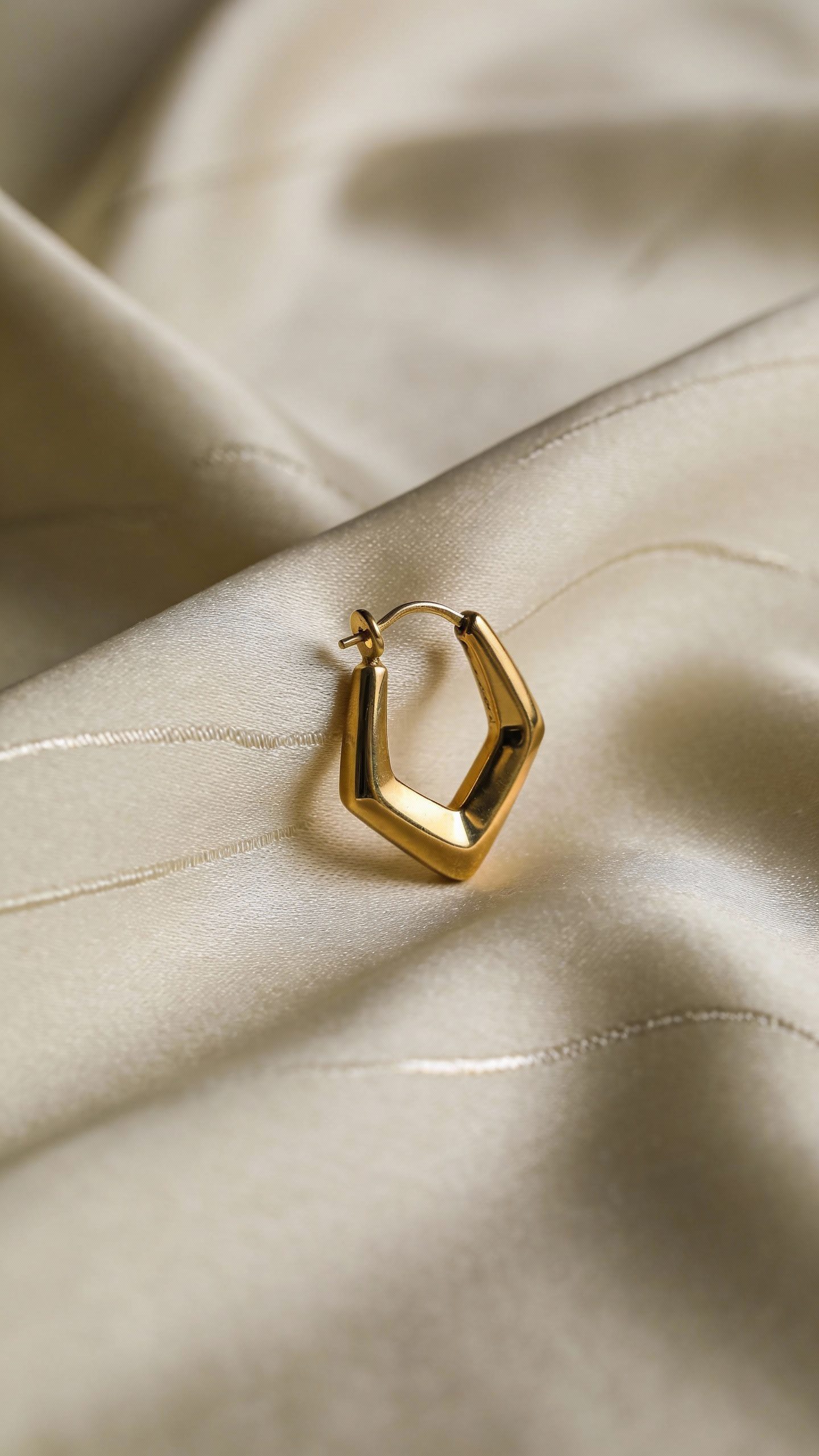 **Single gold statement earring on silk scarf background**  

Each prompt focuses on a key element from the article (neutral base, texture, silhouette, accessories) while keeping the composition minimal and professional.