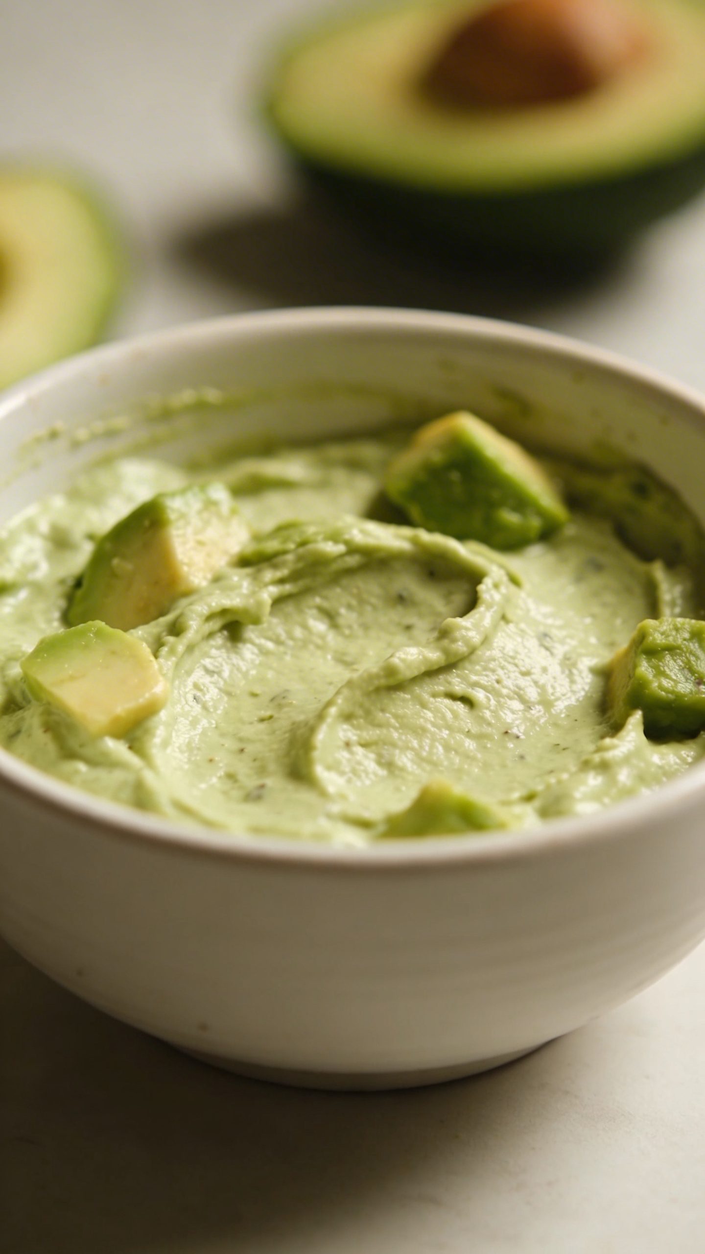 closeup of avocado face mask on single white ceramic bowl
