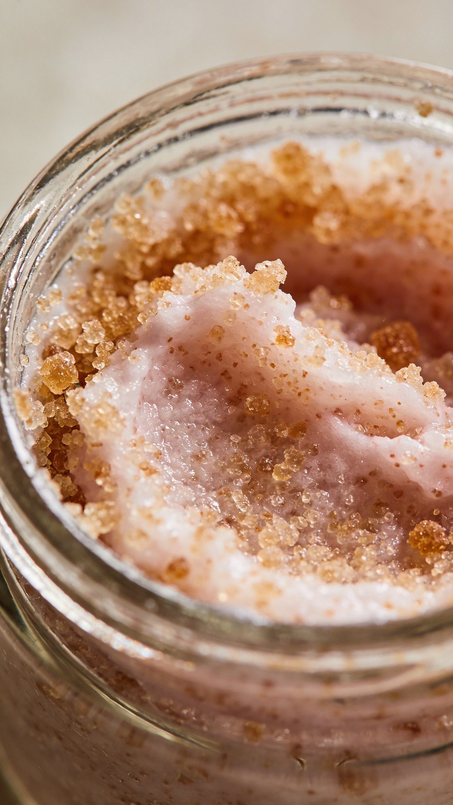 closeup of sugar face scrub in clear glass jar