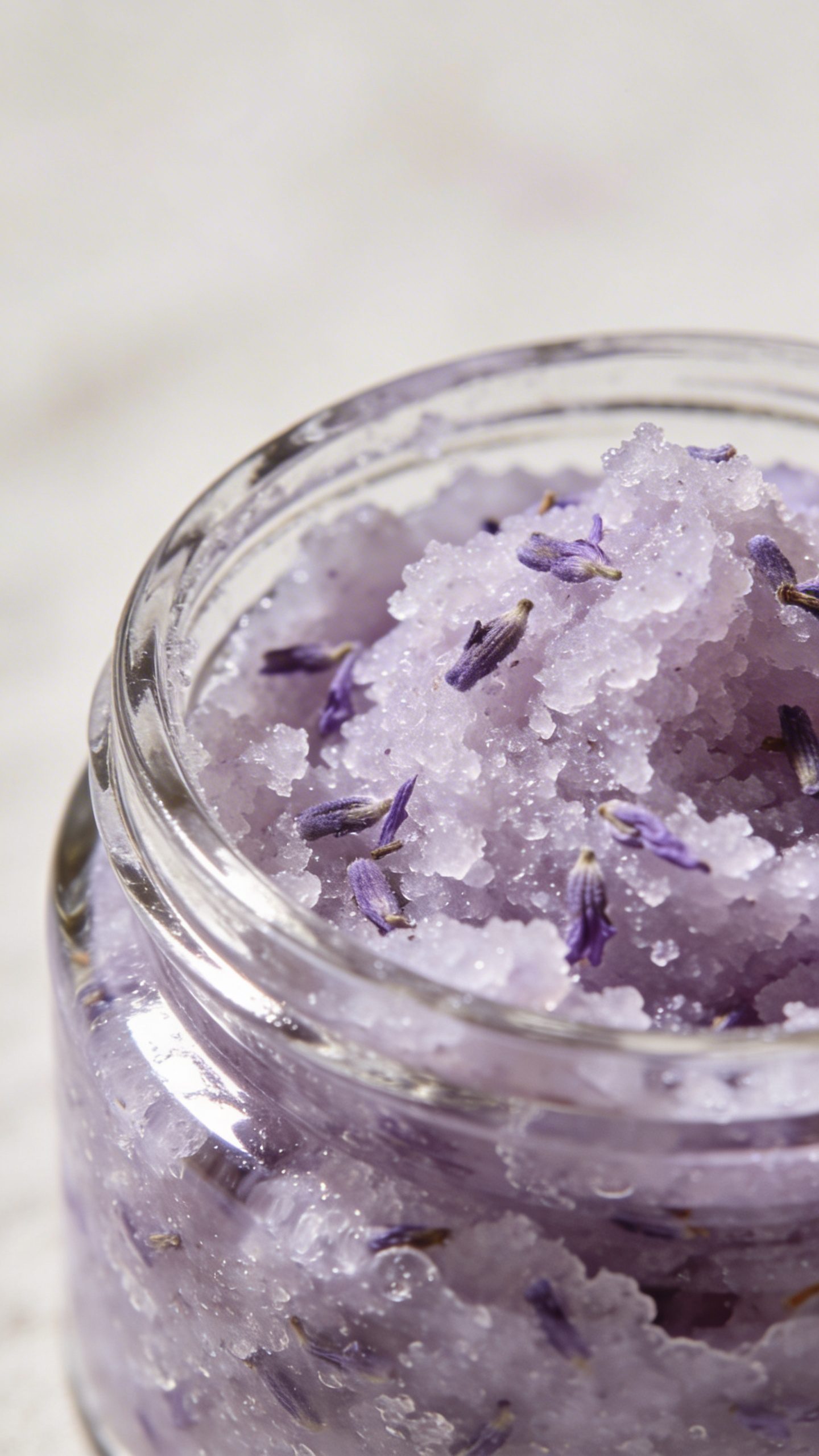 closeup of lavender sugar scrub in clear glass jar
