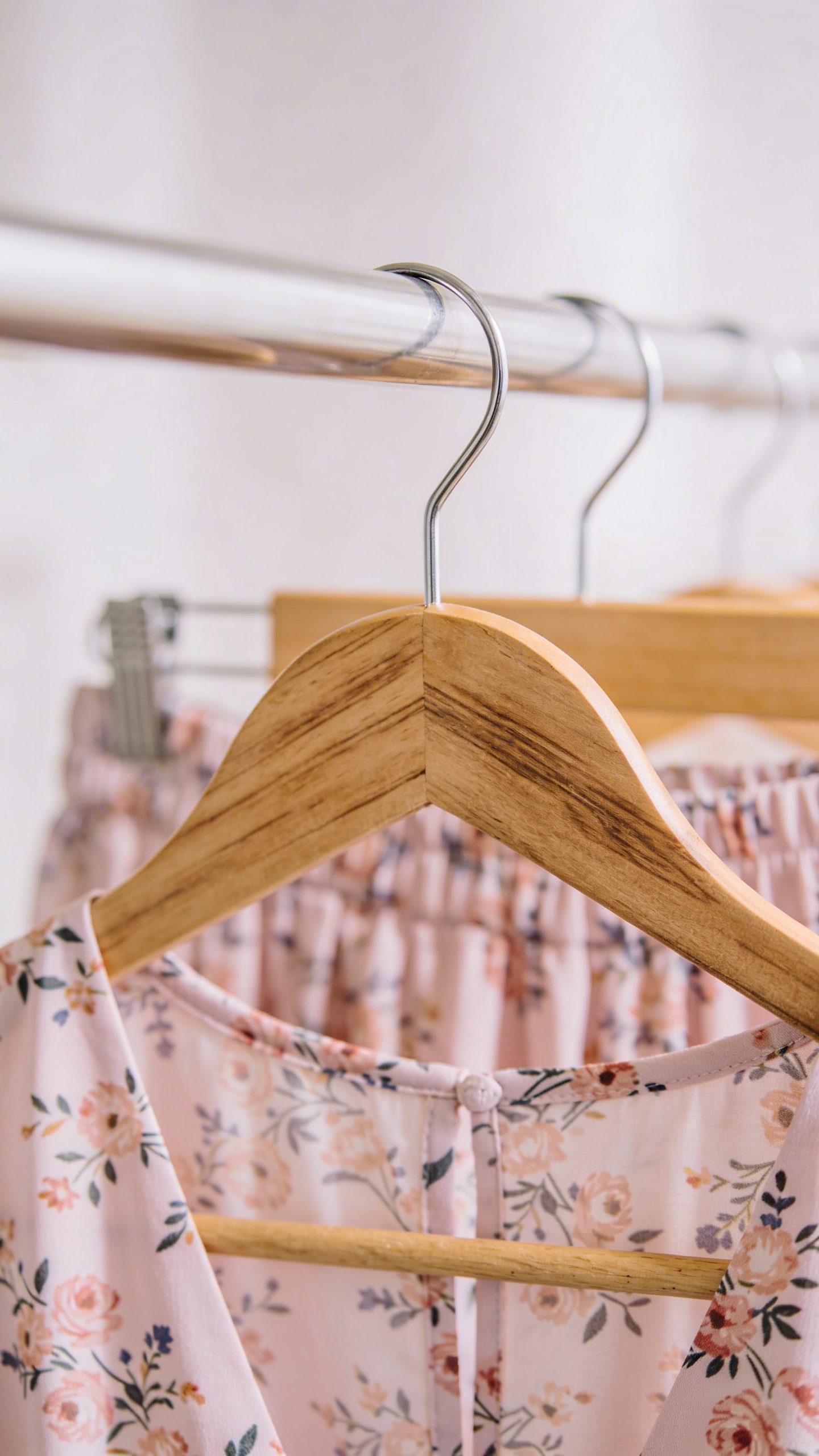 closeup of pastel floral midi dress on wooden hanger